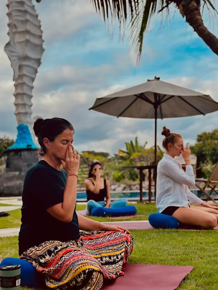Outdoor pranayama practice on the campus lawn during Bali 300 hour YTT