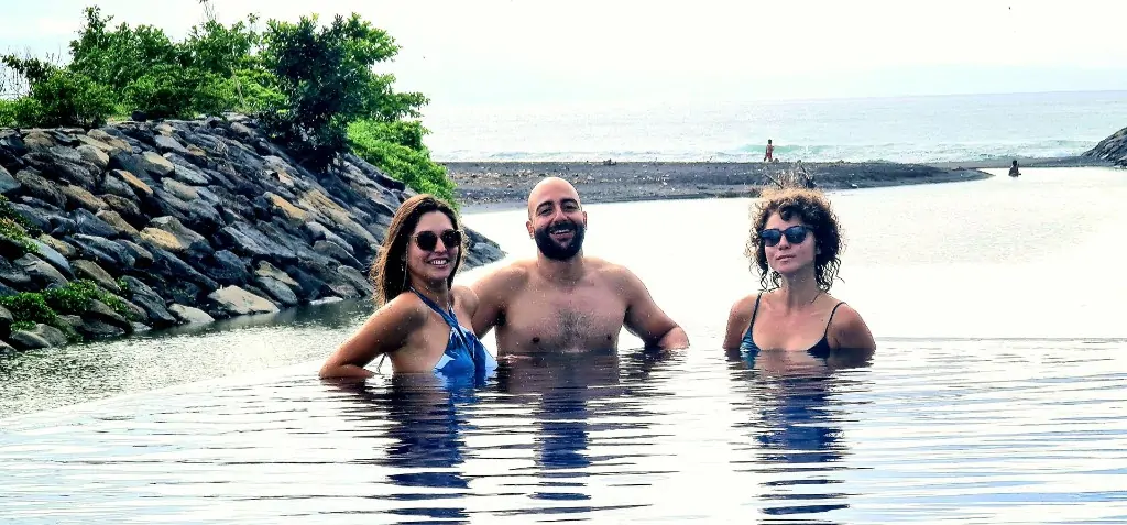 Students in infinity pool with ocean view at Divinepath Bali campus