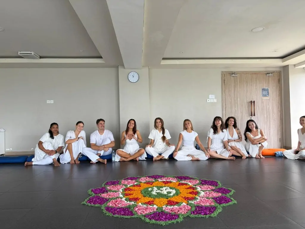 Students with flower mandala in Bali 300 hour campus studio