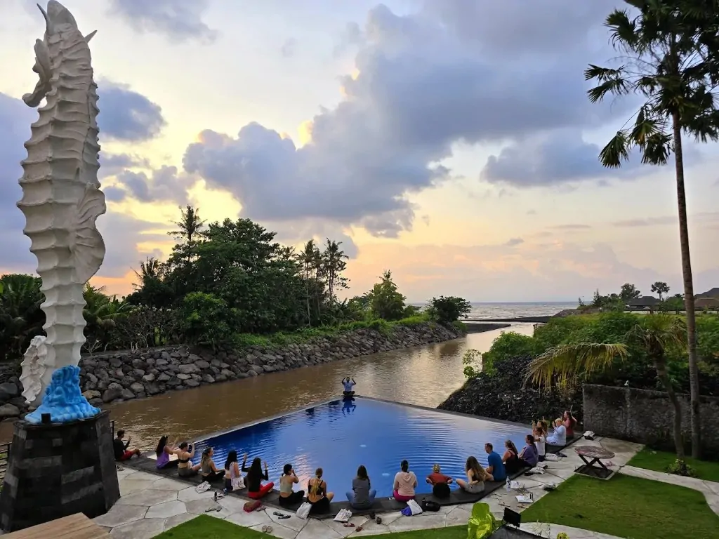 Sunset meditation around the infinity pool at Bali 300 hour YTT campus