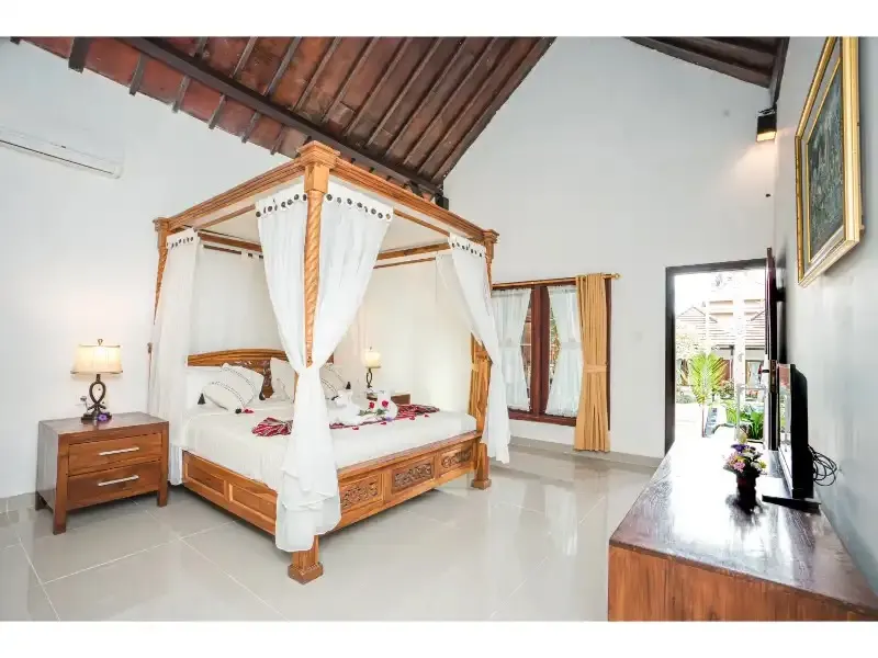 Private room with four-poster bed at DivinePath Ubud yoga teacher training campus