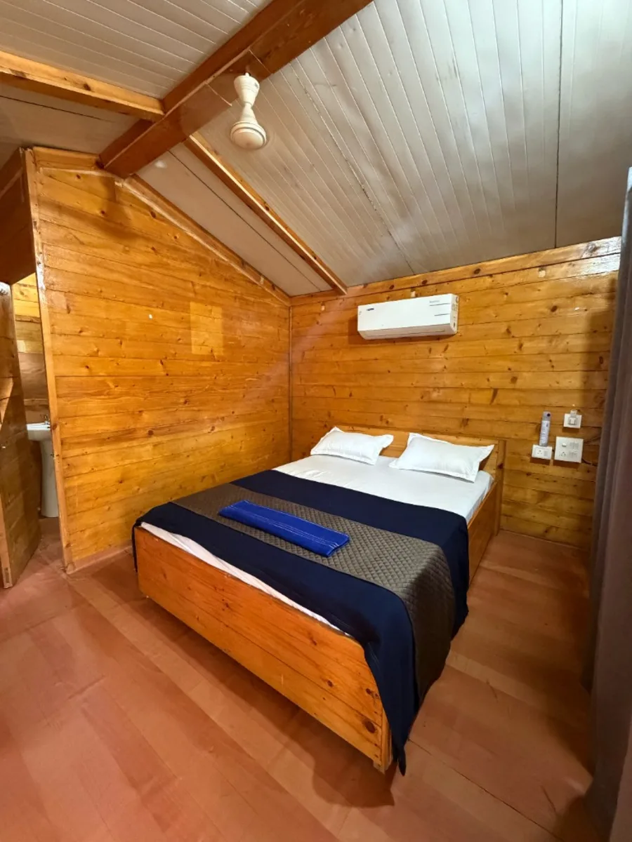 Private wooden cottage bedroom with AC for 300 hour YTT Goa students
