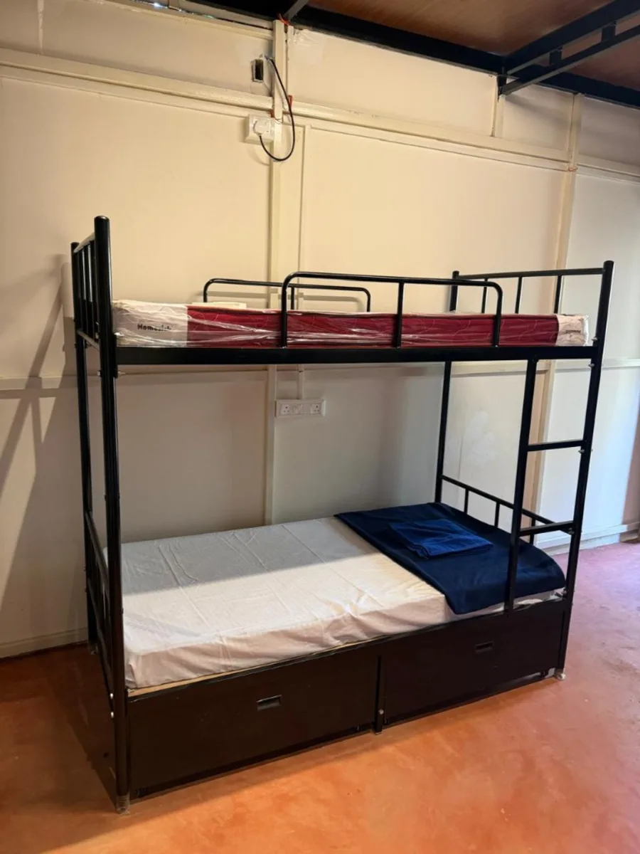 Clean dorm bunk bed with mattress and bedding for 300 hour YTT Goa students