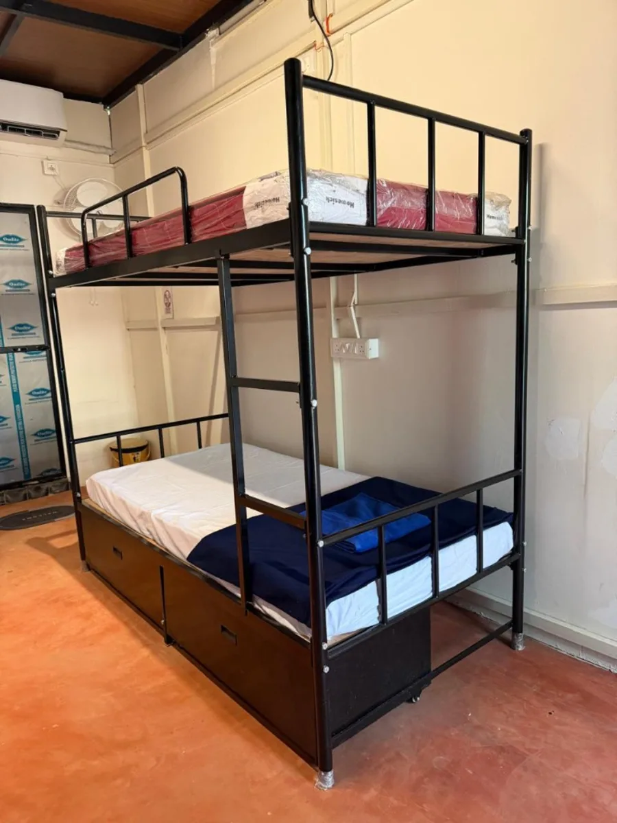Dorm bunk bed with storage for budget accommodation during 300 hour YTT in Goa