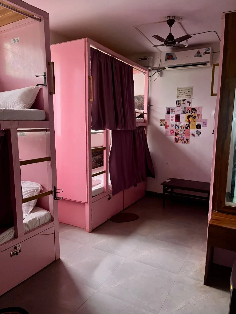 Clean shared dorm room with bunk beds for yoga teacher training students at DivinePath, North Goa