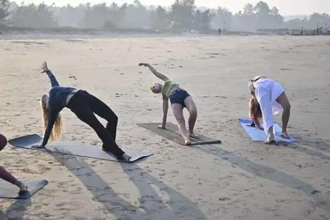 Group asana practice on Arambol Beach, Goa