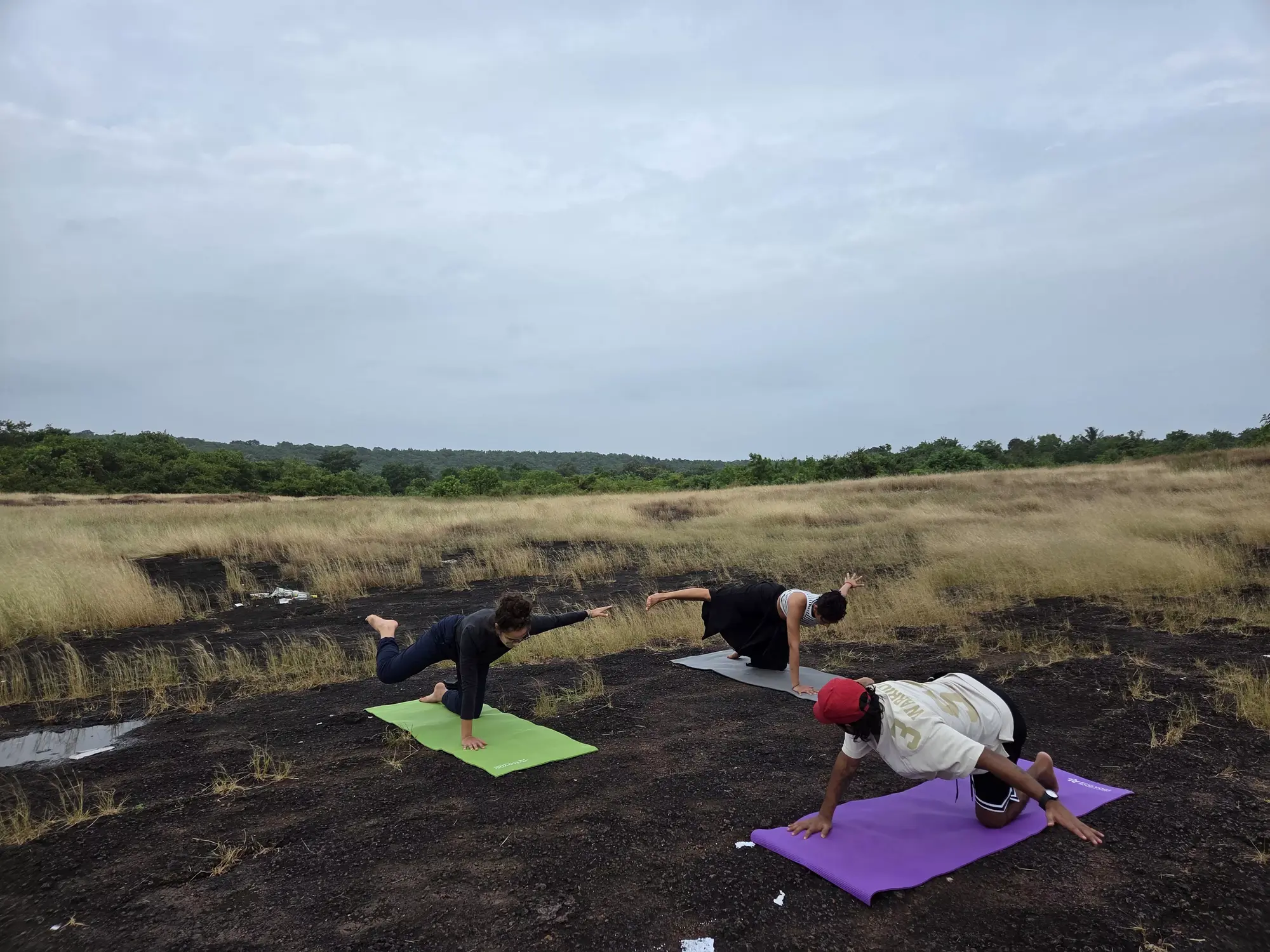 Students in a yoga teacher training class in beach Goa