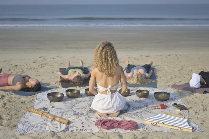 Tibetan singing bowls arranged for a beach sound healing session