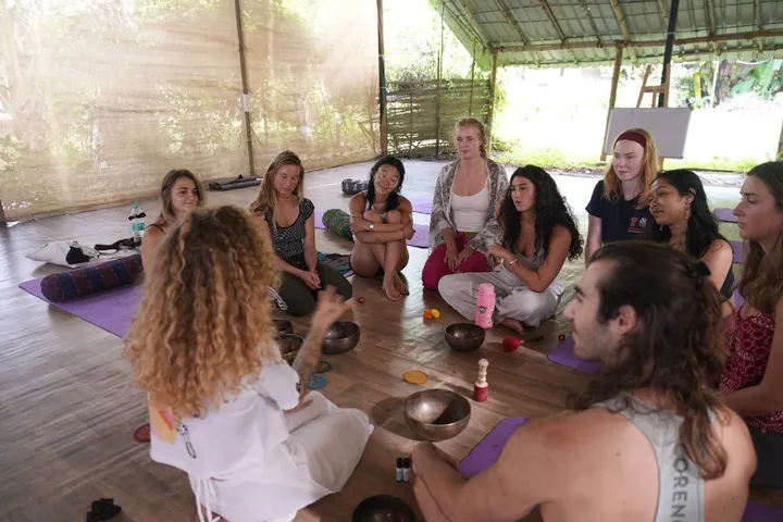 Instructor teaching sound healing instruments to a small group in Goa