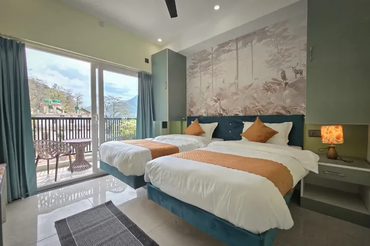 Shared cottage room with twin beds and mountain view at DivinePath Rishikesh