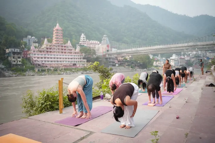 Yoga training on the Ganga ghat during Ashtanga practice at DivinePath’s Rishikesh campus