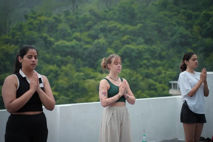 Students in a closing prayer during Ashtanga yoga training at DivinePath Rishikesh