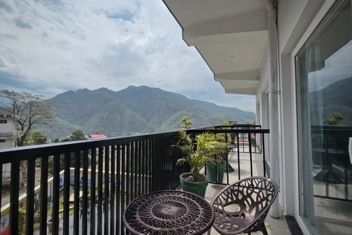 Room balcony overlooking Himalayan foothills in Rishikesh