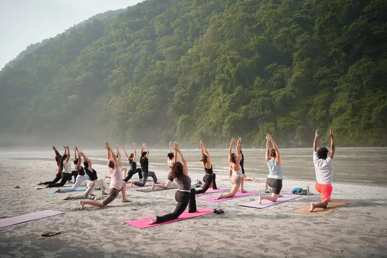 Morning Ashtanga practice by the Ganga on a 200 hour YTT Rishikesh course at Divinepath