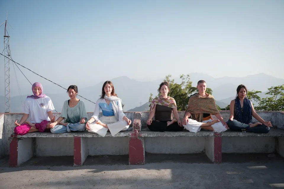 Rooftop meditation overlooking Himalayan hills