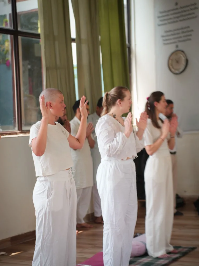 Outdoor high lunge yoga by the river Rishikesh