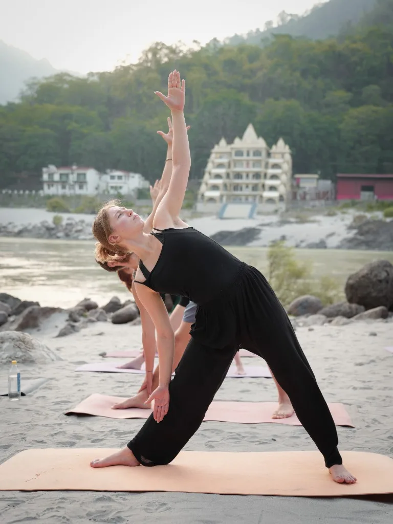 Triangle pose yoga by the Ganges Rishikesh