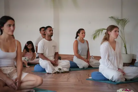 Group seated in a circle in the Tapovan hall