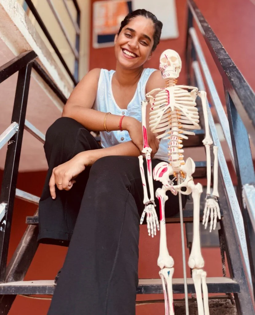 Ayushi Tondon — lead yoga teacher at Divinepath Goa with anatomy teaching model