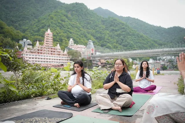 Prenatal yoga trainees meditating on the Ganga riverside in Tapovan, Rishikesh