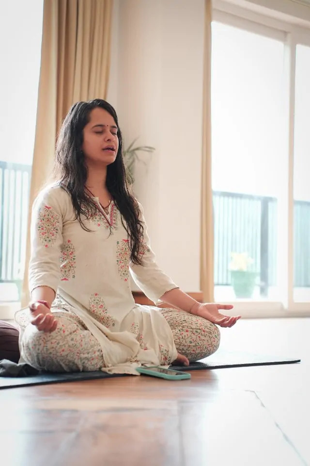 Trainee in seated meditation and pranayama during prenatal yoga teacher training in Rishikesh