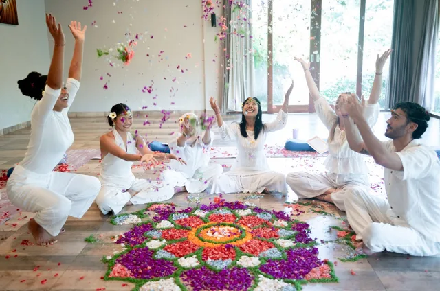 Students celebrating graduation at Divinepath Bali 200-hour YTT with flower mandala ceremony